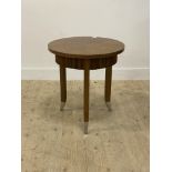 A contemporary oak lamp table, the circular top above a reeded frieze, raised on square tapered