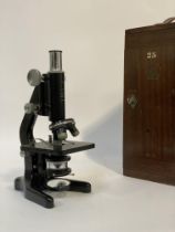 An early to mid 20th century "Kima" monocular microscope by W Watson & Sons, London, in a mahogany