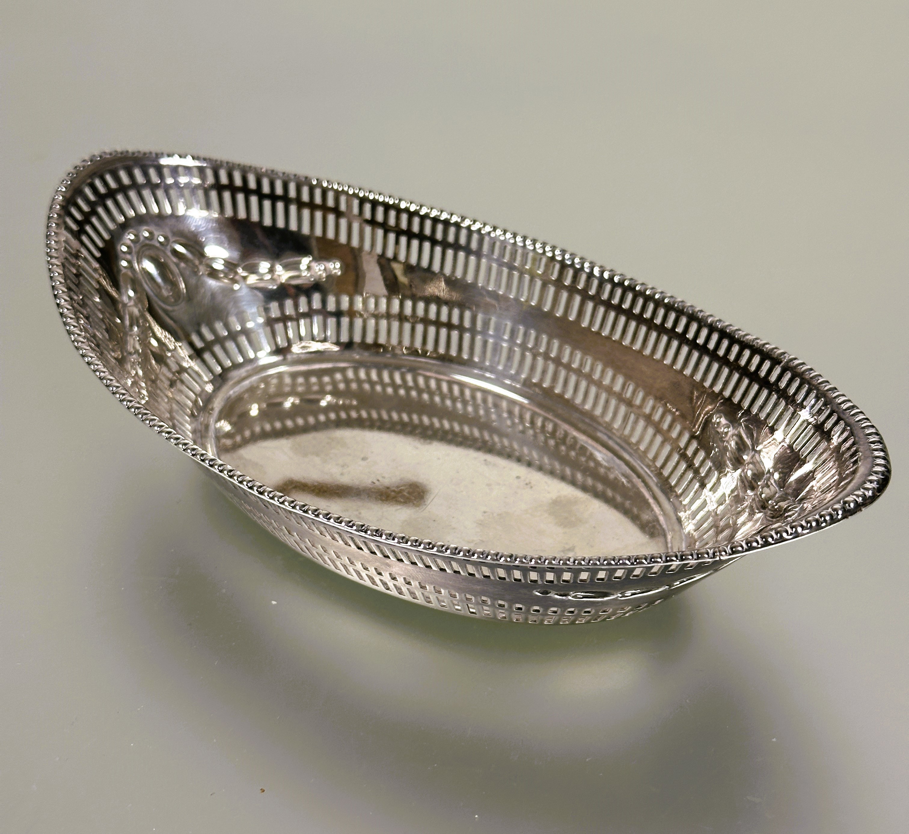 A late Victorian Sheffield silver navette shaped nut dish with beaded pierced border and chased