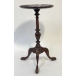 A Georgian style mahogany tripod wine table, the circular top raised on a turned column and triple