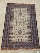 A hand knotted soumak rug, early to mid 20th century, the beige ground decorated with stylised