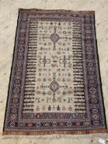 A hand knotted soumak rug, early to mid 20th century, the beige ground decorated with stylised