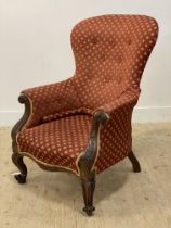 A Victorian mahogany framed and upholstered armchair, with floral carved show frame and raised on