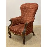 A Victorian mahogany framed and upholstered armchair, with floral carved show frame and raised on