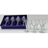 A boxed set of four Edinburgh Crystal wine glasses with star cut design (h- 18cm, with paper