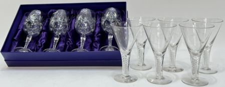 A boxed set of four Edinburgh Crystal wine glasses with star cut design (h- 18cm, with paper