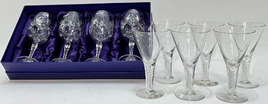 A boxed set of four Edinburgh Crystal wine glasses with star cut design (h- 18cm, with paper