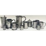 A large group of pewter comprising nine mugs or tankards (largest h- 17.5cm, w- 19cm), a lidded pot,