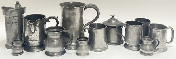 A large group of pewter comprising nine mugs or tankards (largest h- 17.5cm, w- 19cm), a lidded pot,