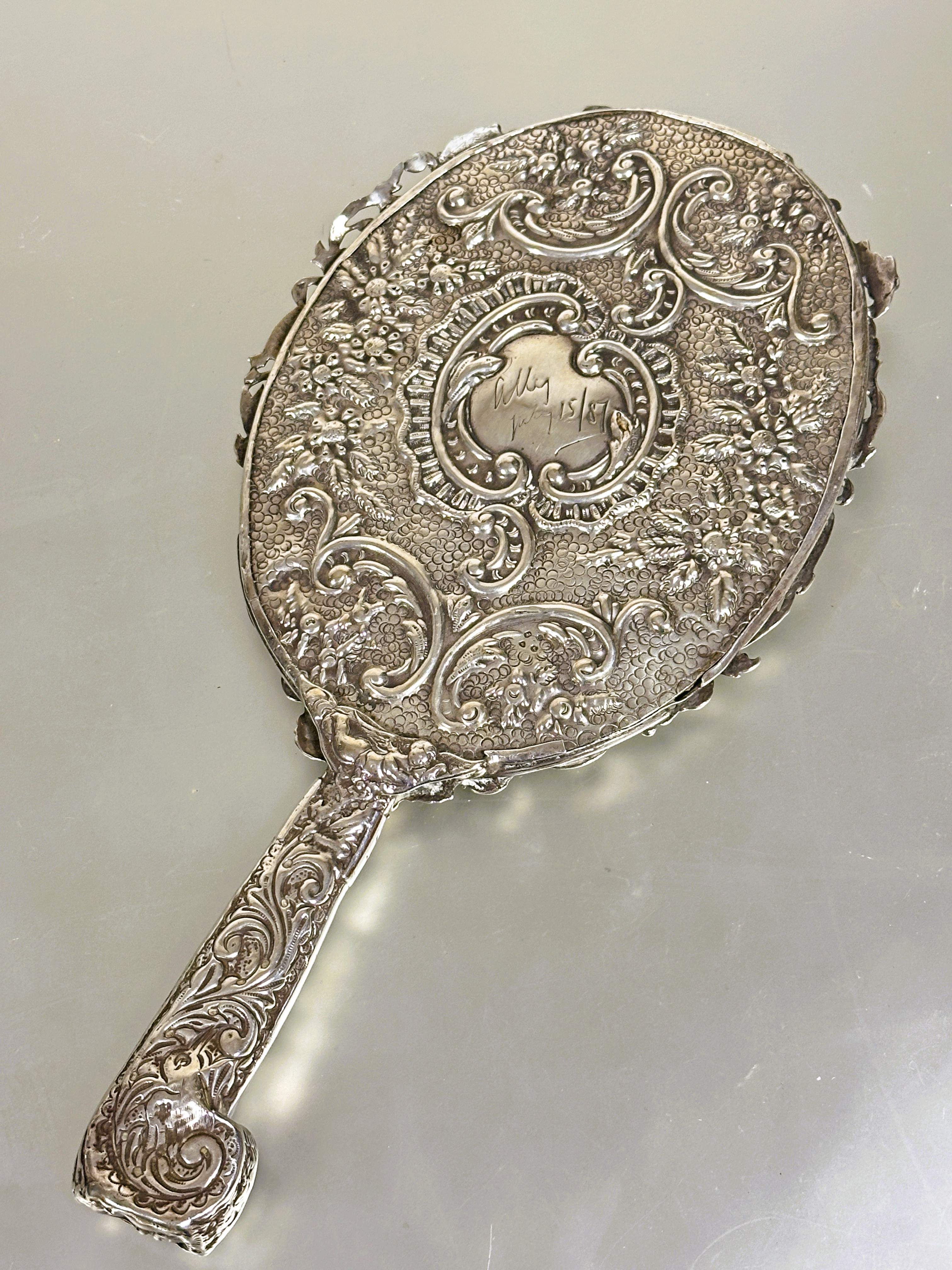 A Victorian London silver hand mirror with cast engraved scrolling border decorated with birds, - Image 2 of 4