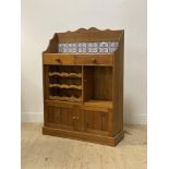 A late 20th century pine kitchen cabinet, the raised back inset with tiles and two drawers, above