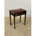 An Edwardian mahogany piano stool with upholstered hinged seat raised on square tapered supports