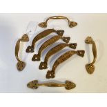 A set of four late 19th / early 20th century brass door handles, (L18cm) together with another set