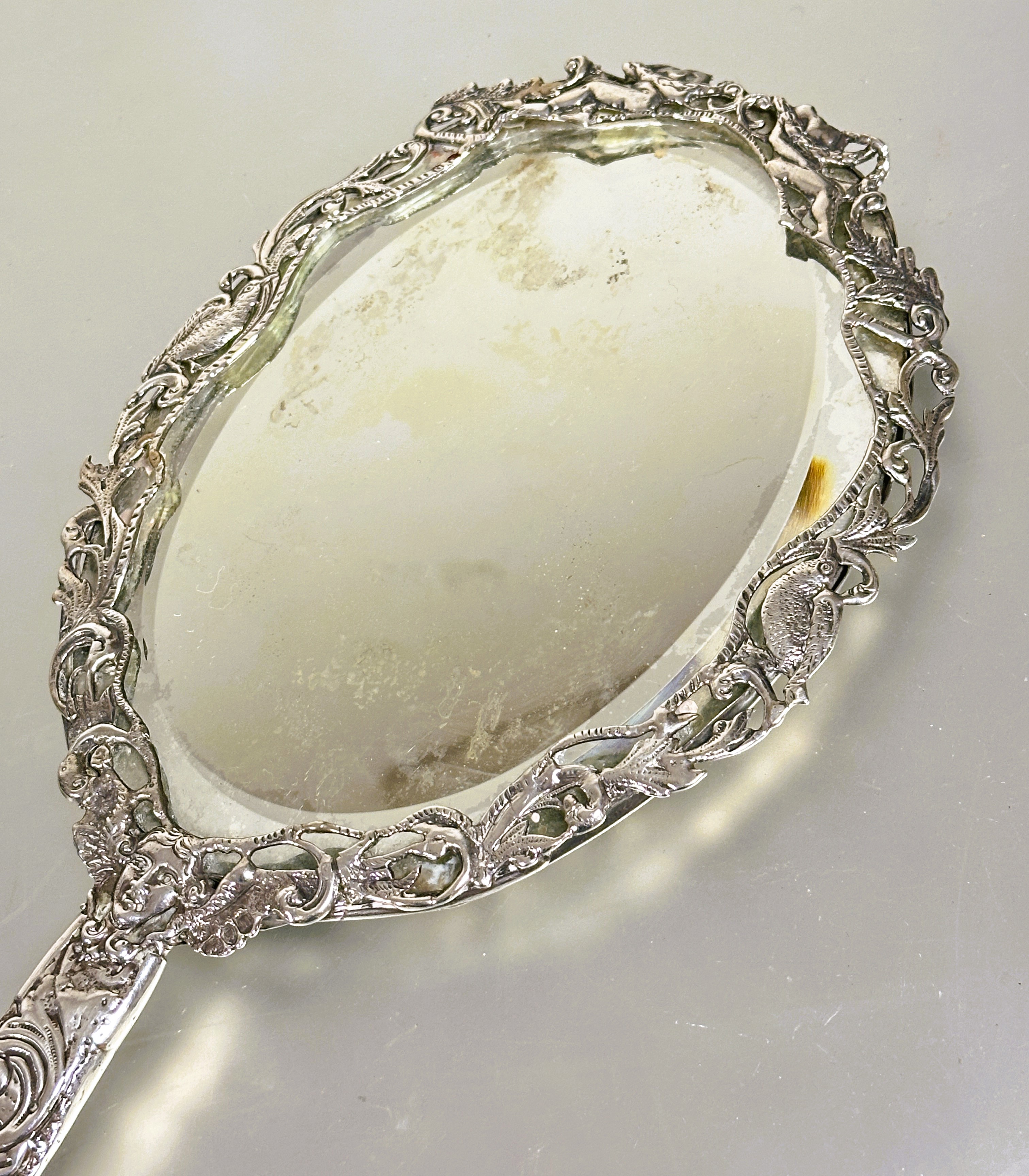 A Victorian London silver hand mirror with cast engraved scrolling border decorated with birds, - Image 4 of 4
