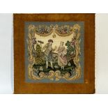 A 19hc style needle-point tapestry of a man courting a woman with a brown fabric boarder on board,