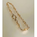 A 9ct gold oval bar and chain link bracelet with loop clasp fastening D x 9cm 4.56g
