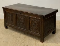 An 18th century oak coffer of pegged and jointed contruction, the hinged lid opening to an