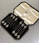 A Sheffield silver set of twelve seal handled tea spoons and matching pair of tongs in original