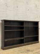 A Edwardian stained walnut open bookcase, fitted with five adjustable shelves on a plinth base.
