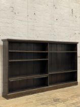 A Edwardian stained walnut open bookcase, fitted with five adjustable shelves on a plinth base.