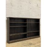 A Edwardian stained walnut open bookcase, fitted with five adjustable shelves on a plinth base.