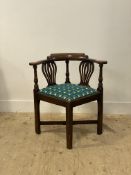 A George III elm corner chair, late 18th century, the shaped crest rail and out-swept arms on two