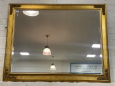 A large gilt composition framed wall hanging mirror. 114cm x 140cm.
