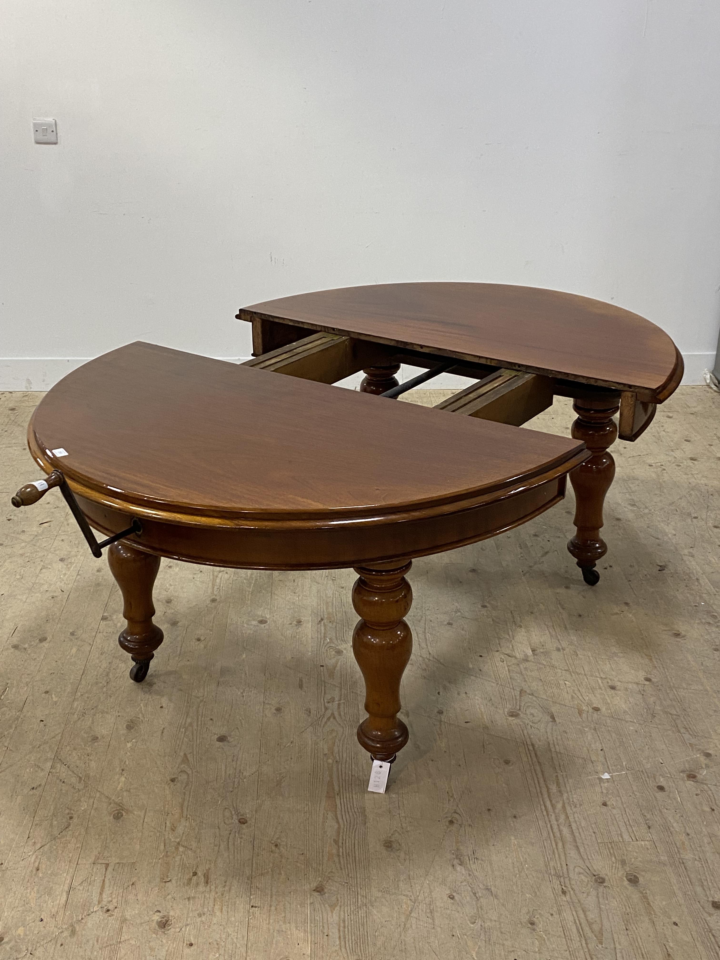 A Victorian mahogany wind out extending dining table, the oval top with two leaves, raised on turned - Image 4 of 4
