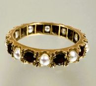 A yellow metal ten stone garnet and seed pearl alternating eternity style ring Q/R 3.26g