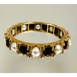 A yellow metal ten stone garnet and seed pearl alternating eternity style ring Q/R 3.26g
