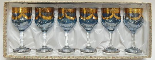 A boxed set of six blue and clear glass stemmed goblets/wine glasses, with gilt swag decoration (