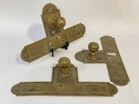 A set of three mid to late 19th century brass door knobs with integrated finger plates. L42cm.