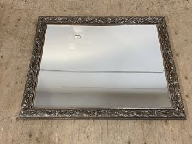 A traditional silvered composition wall mirror with bevelled glass. 110cm x 136cm.