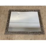 A traditional silvered composition wall mirror with bevelled glass. 110cm x 136cm.