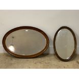 An early 20th century mahogany framed oval wall hanging mirror with bevelled glass, 82cm x 57cm,