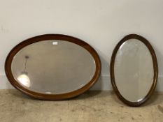 An early 20th century mahogany framed oval wall hanging mirror with bevelled glass, 82cm x 57cm,