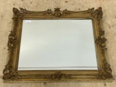 A 19th century and later gilt composition framed wall mirror. 90cm x 73cm.