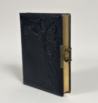 An Edwardian/Victorian leather bound photo album with a brass clip to side with gilt edging, and