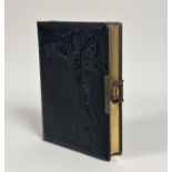 An Edwardian/Victorian leather bound photo album with a brass clip to side with gilt edging, and