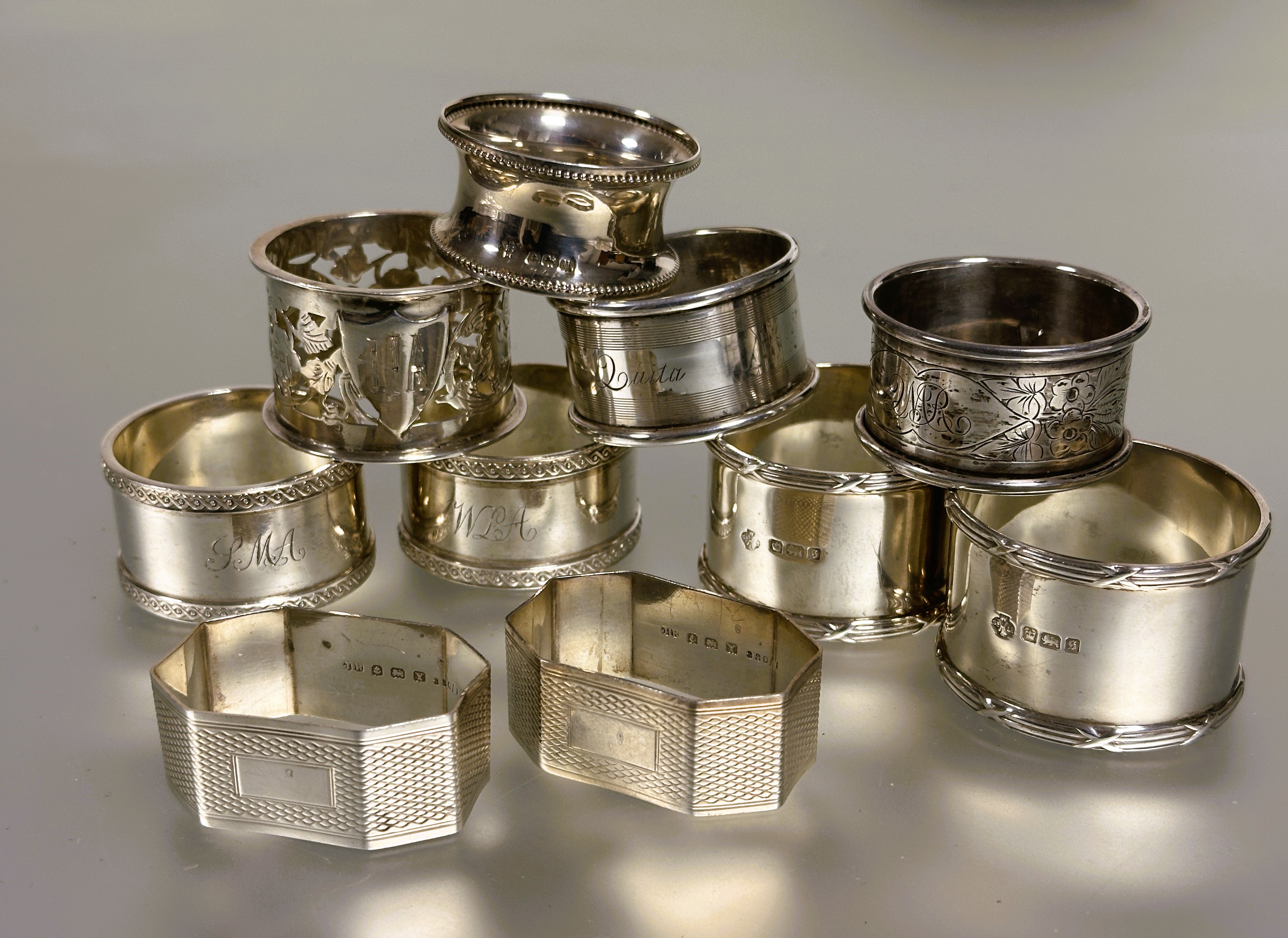 A collection of silver napkin rings to include a pair of Sheffield silver reeded bordered design