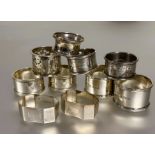 A collection of silver napkin rings to include a pair of Sheffield silver reeded bordered design