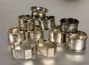 A collection of silver napkin rings to include a pair of Sheffield silver reeded bordered design