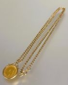 A Edward VII gold half sovereign 1902 in yellow metal frame on a 9ct gold belcher link chain