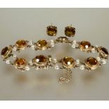 A 9ct gold bracelet set ten circular faceted 1ct citrines mounted in rope pattern border mounted