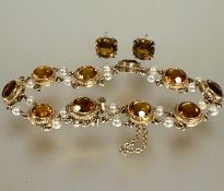 A 9ct gold bracelet set ten circular faceted 1ct citrines mounted in rope pattern border mounted