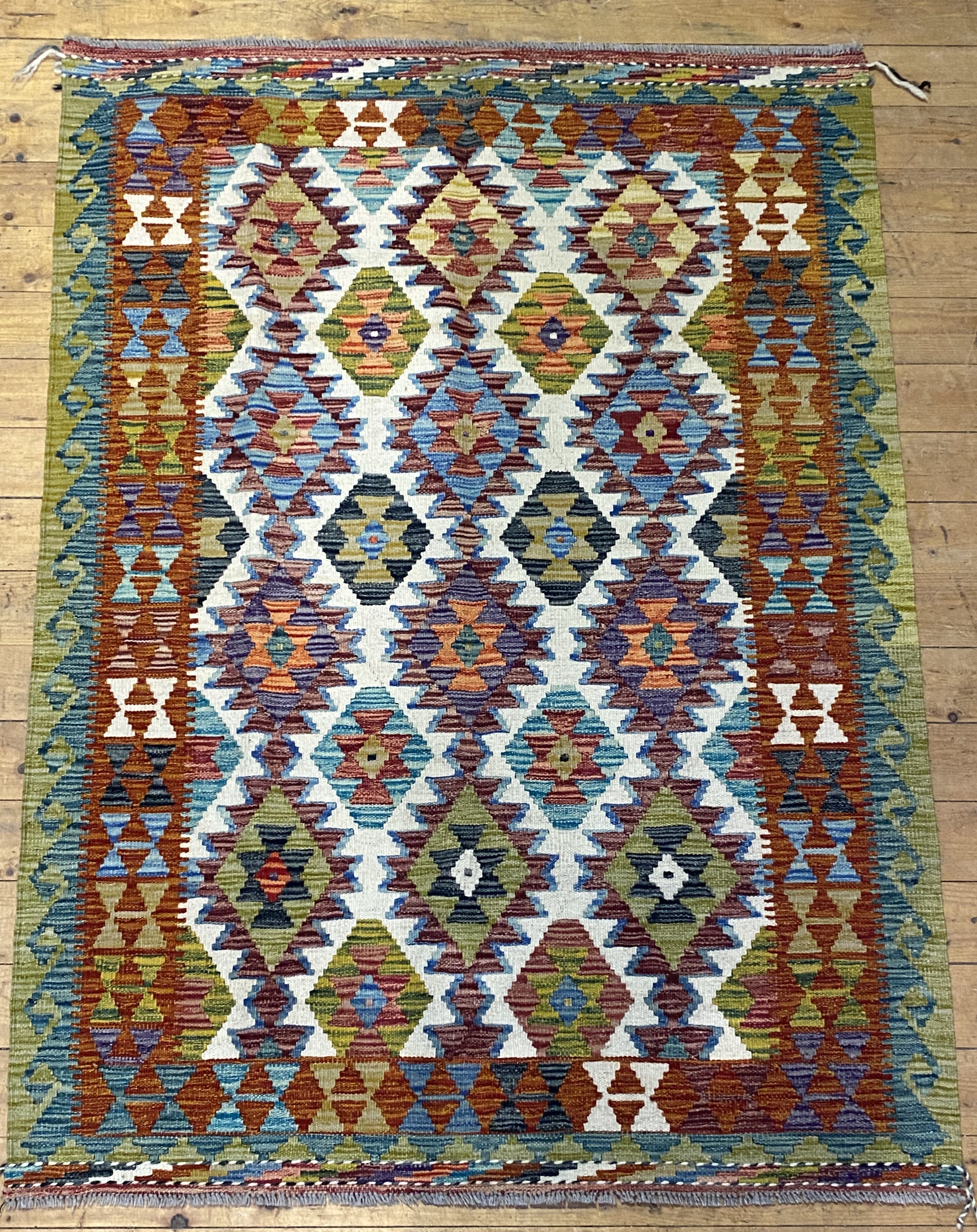 A flatweave chobi kilim rug of typical design. 174cmx  127cm.