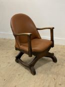 A small oak framed open armchair, circa 1930's, the seat and back upholstered in tan faux leather,