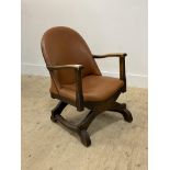 A small oak framed open armchair, circa 1930's, the seat and back upholstered in tan faux leather,