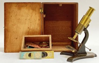 A Victorian Lacquered brass microscope together with original box and draw of slides/specimins and
