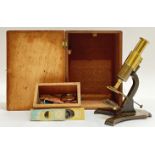 A Victorian Lacquered brass microscope together with original box and draw of slides/specimins and